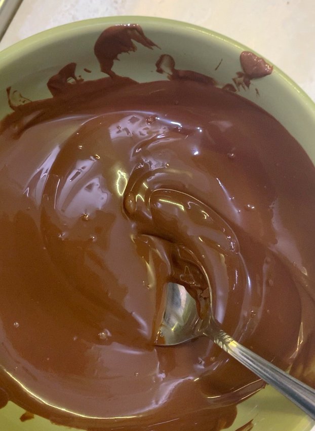 3. Melt milk chocolate in a bowl and stir. (Heat in microwave for 30 seconds, then at 15-second intervals until chocolate reaches 115F; temper with more chocolate until mixture reaches 88F.)